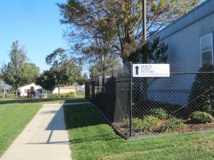 Pathway beside fence under a clear sky