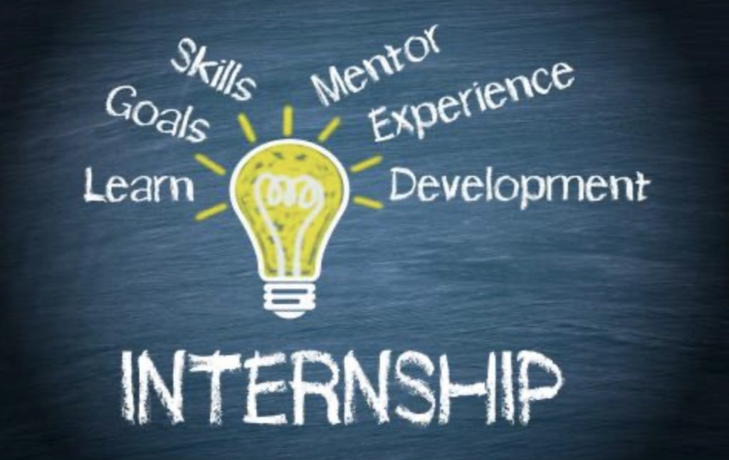 A chalkboard drawing shows a lightbulb with words around it: Skills, Goals, Mentor, Experience, Learn, and Development. Below the lightbulb, the word INTERNSHIP is written in bold white letters.